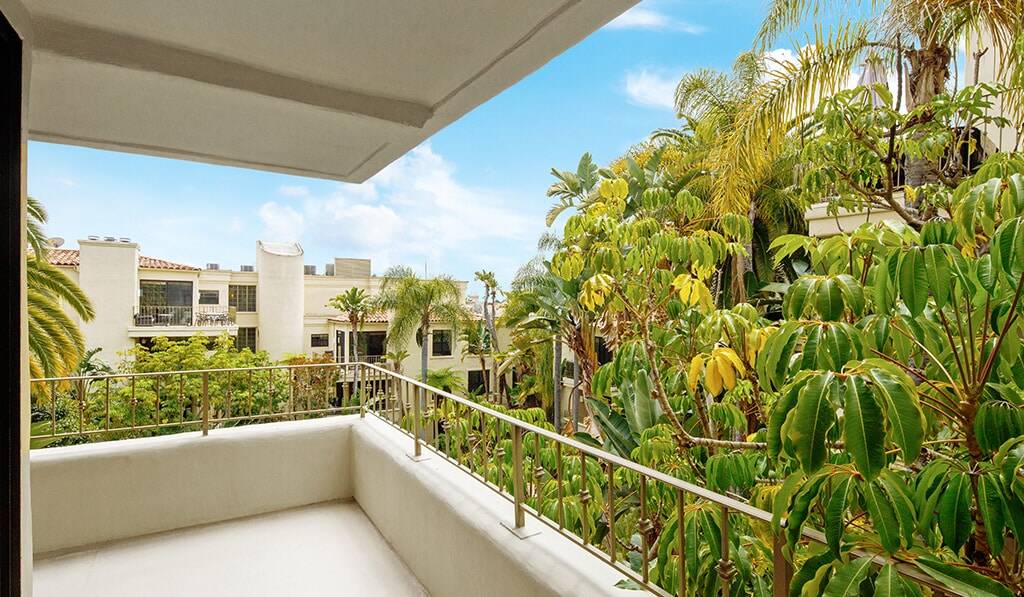 Expansive balcony overlooks courtyard and pool