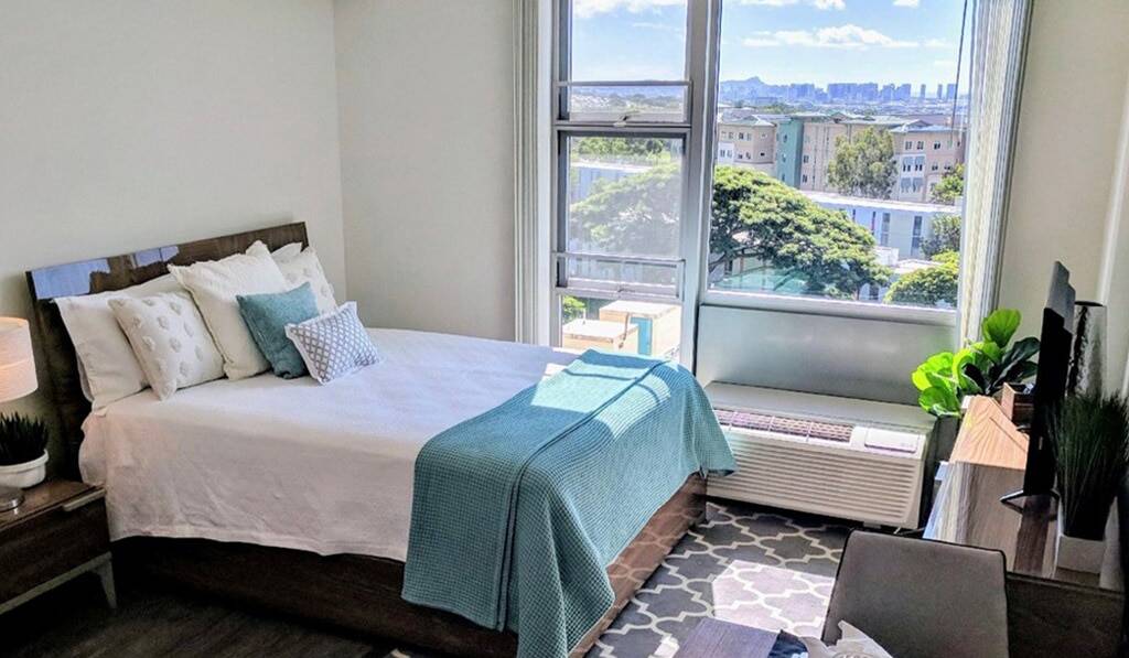 furnished bedroom with window view overlooking Honolulu