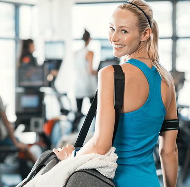 woman in gym woman in gym wearing blue shirt