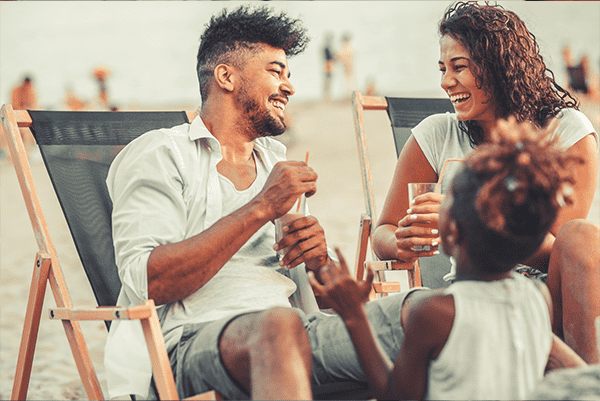 family at the beach laughing