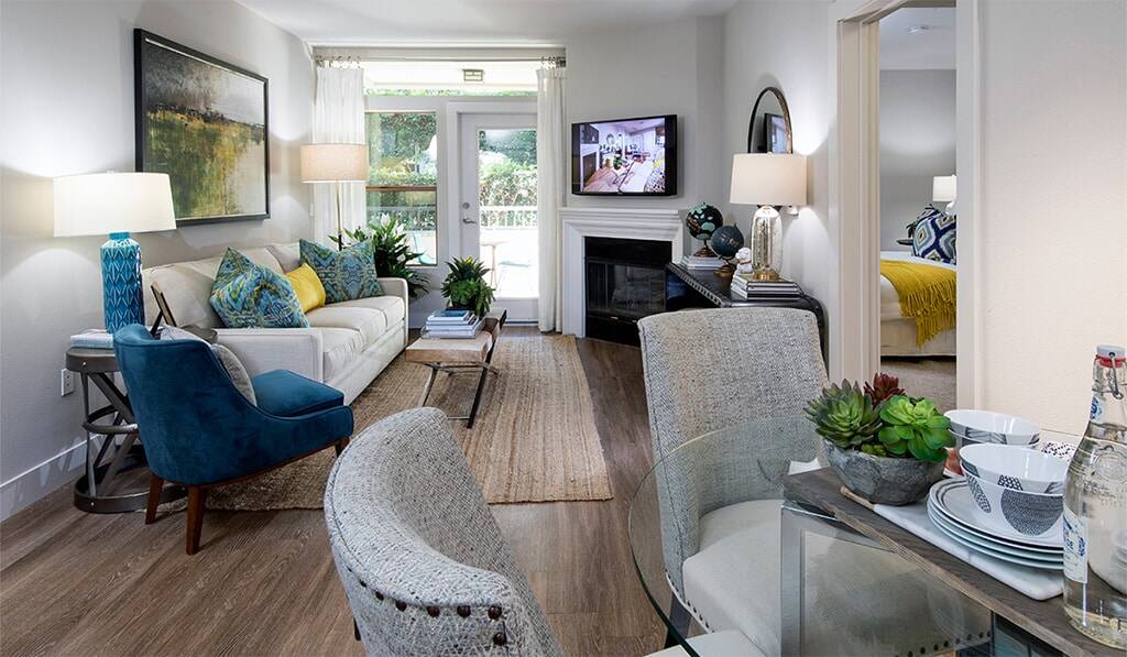 Living room with fireplace shows bedroom