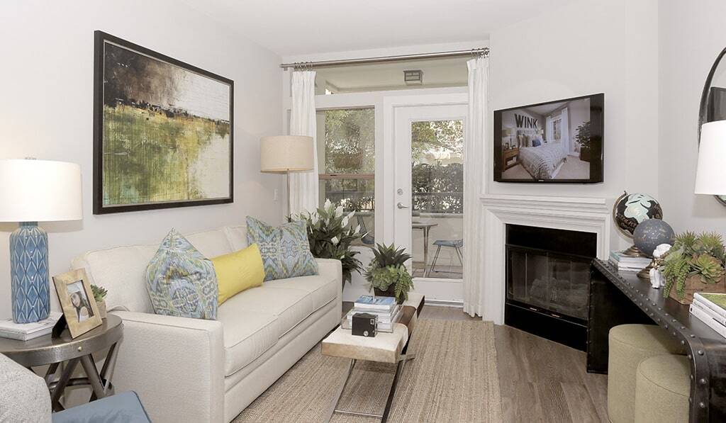 Living room with fireplace leads to balcony